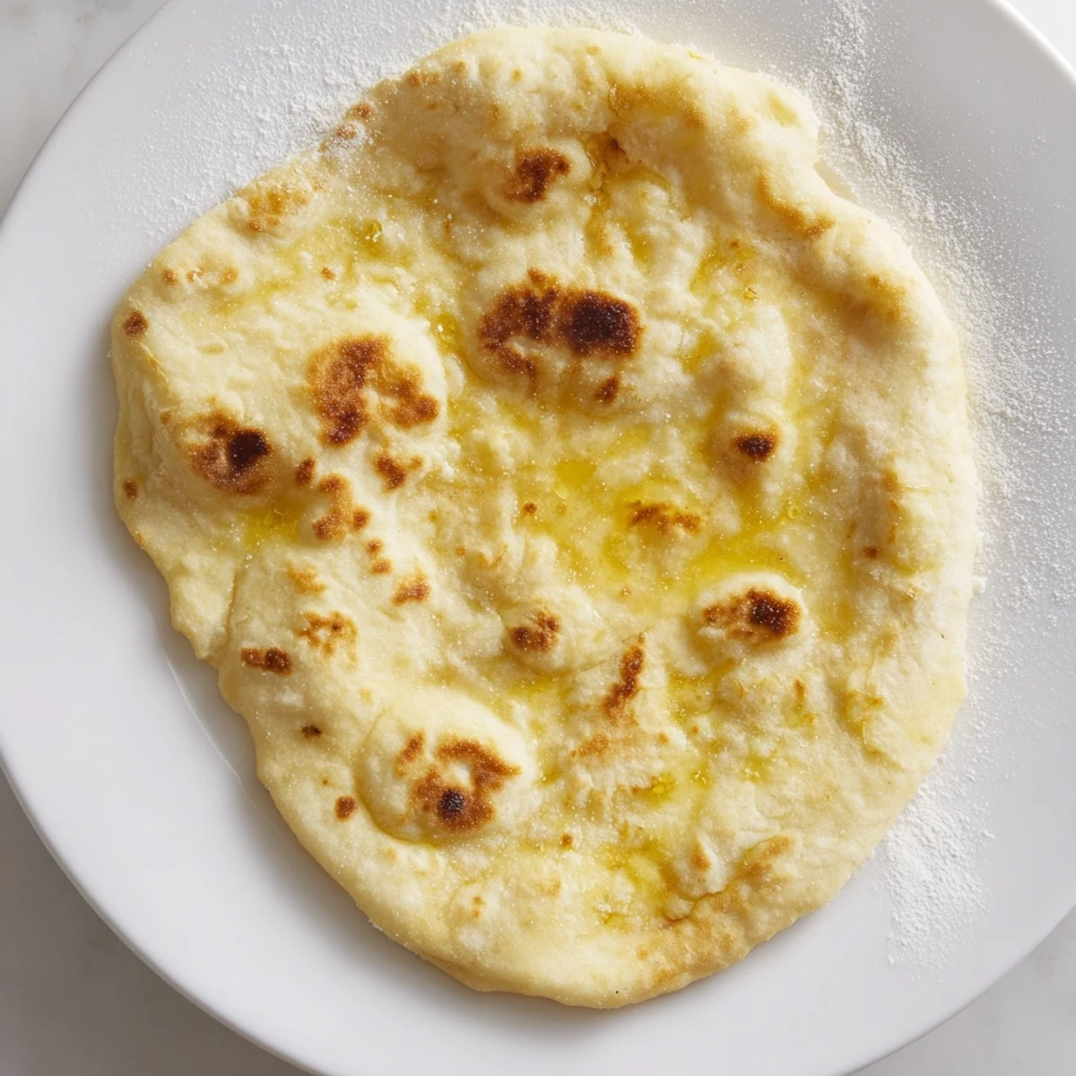 Golden-brown Three-Ingredient Easy Flatbreads, ready to be ripped open and enjoyed with your favorite dip.