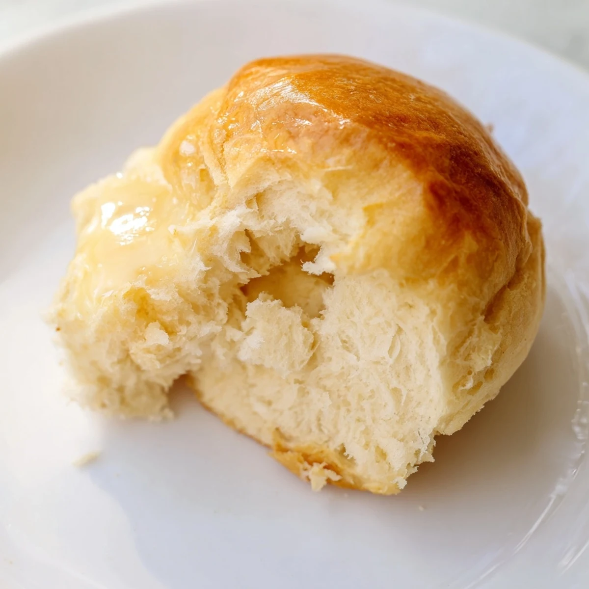 Quick-Rise Dinner Rolls golden-brown, brushed with butter, ready to be served hot from the oven.