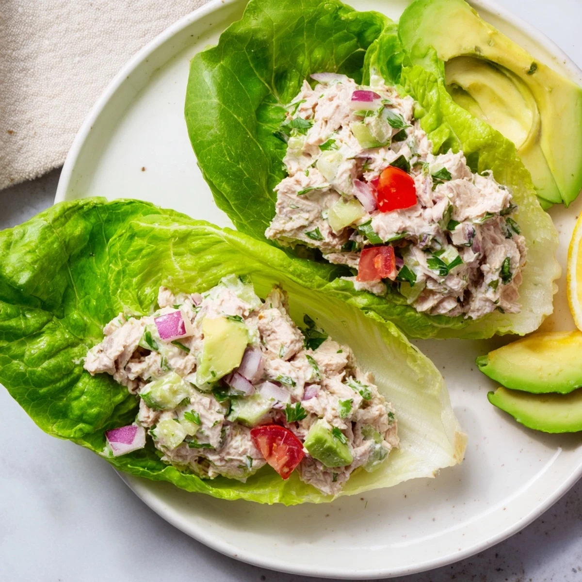 Quick & Healthy Tuna Salad Lettuce Wraps, a light and flaky tuna mixture nestled in vibrant green lettuce.