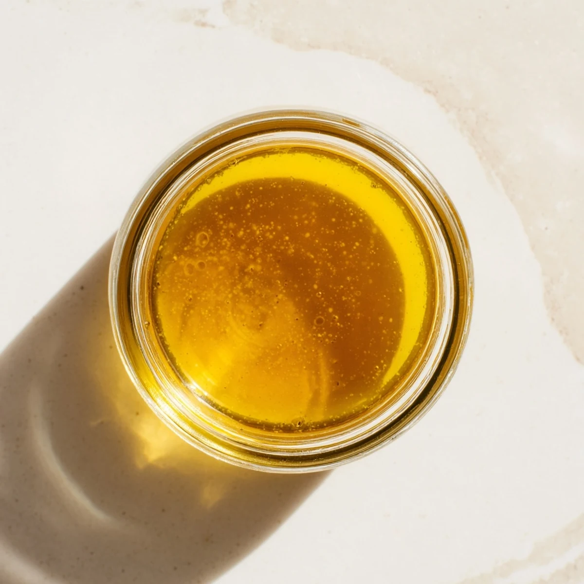Golden honey vinaigrette, emulsified and glistening, ready to drizzle over a fresh salad.