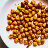 A bowl of oven-roasted chickpea snack tossed with bold spices, perfect for on-the-go snacking.  
