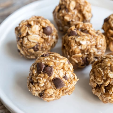 No-bake peanut butter energy balls, ready-to-eat, show oats, chocolate chips, and peanut butter goodness.