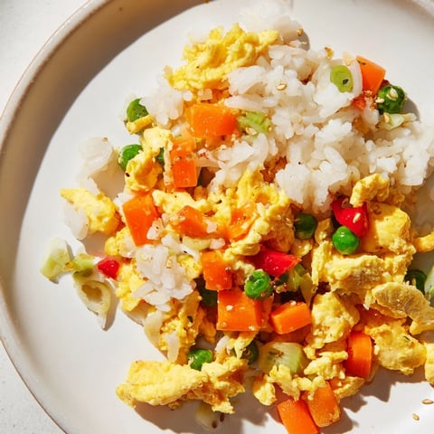 Golden-brown Egg Fried Rice with colorful veggies, ready to serve as a quick weeknight meal.