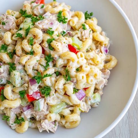 Chilled Chicken Macaroni Holiday Salad, showcasing tender chicken and crunchy celery, ready to serve.