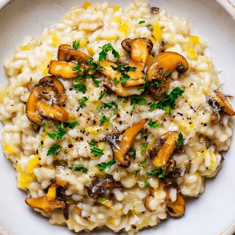 A close-up view of perfectly cooked mushroom risotto, boasting creamy Parmesan goodness.