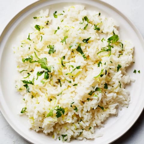A close-up of vibrant cilantro lime rice; the rice is fluffy and aromatic, perfect side.