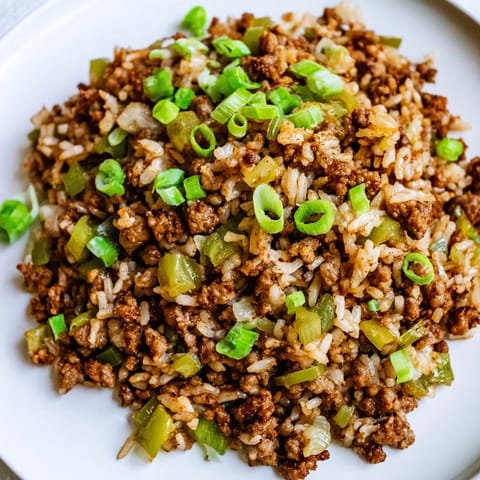 This image shows a bowl of flavorful Cajun Dirty Rice, a comforting and well-seasoned rice dish.