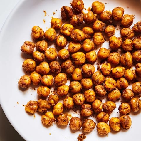 A bowl of oven-roasted chickpea snack tossed with bold spices, perfect for on-the-go snacking.  