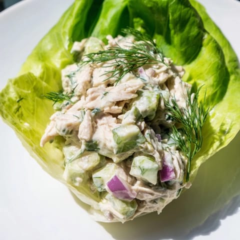 Tender Dill Pickle Chicken Salad Lettuce Cups served in cool butter lettuce leaves with fresh dill and red onion.