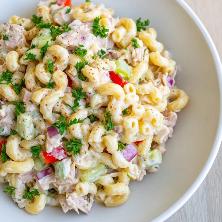 Chilled Chicken Macaroni Holiday Salad, showcasing tender chicken and crunchy celery, ready to serve.