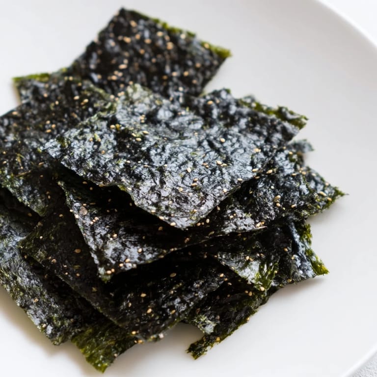 Lightly oiled and salted Roasted Seaweed Chips on a baking sheet, freshly pulled from the oven and cooling.