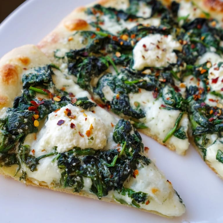 Perfectly baked Spinach Ricotta Pizza with bubbling cheese and herbs, ready to serve as a light, satisfying vegetarian main dish.