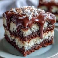 Graduation cake with white chocolate drip and edible gold balloons, perfect for celebrating achievements.  