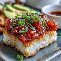 Crispy Rice Salad with Spicy Tuna, featuring golden fried rice cakes and vibrant toppings.